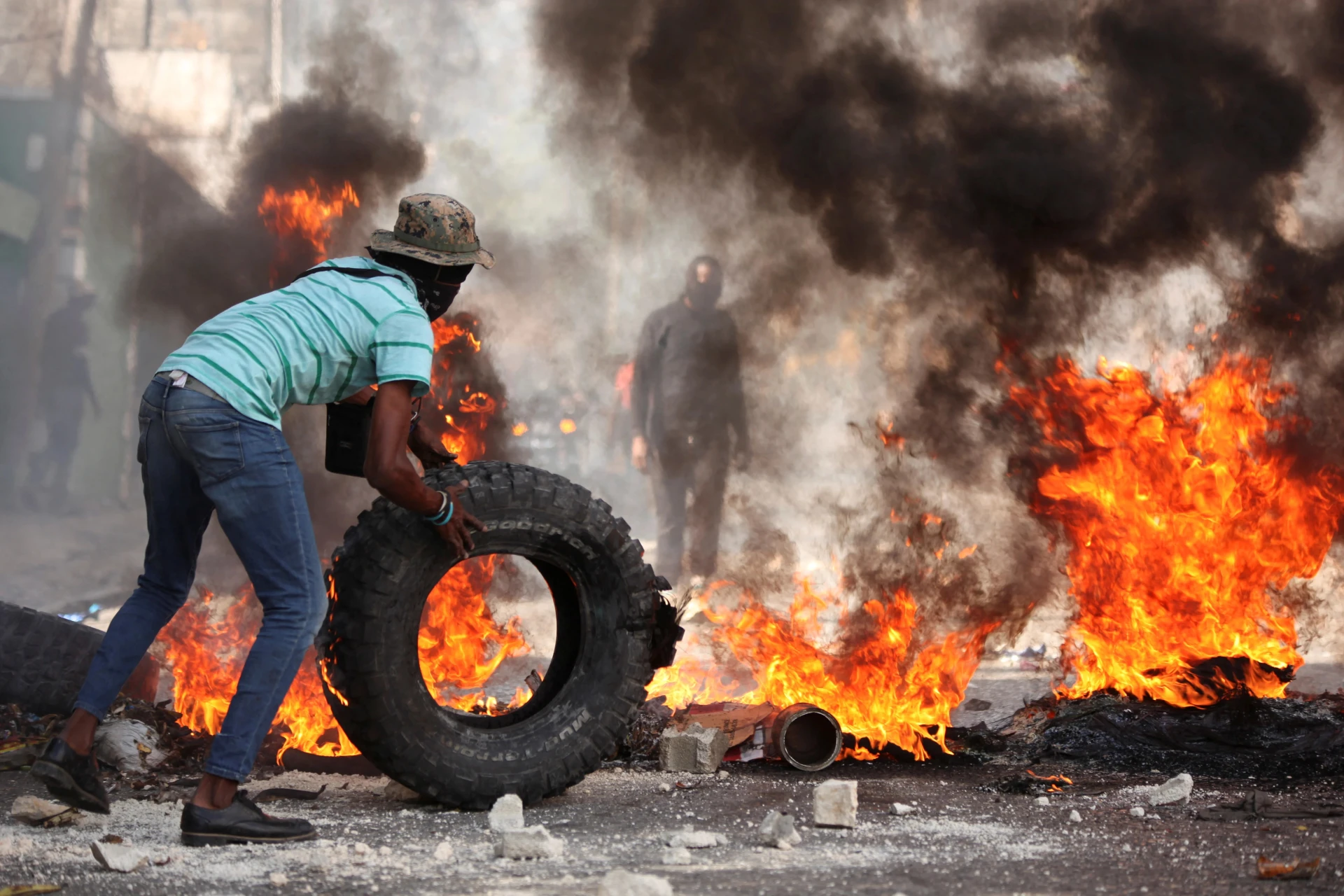 <p>A man adds a tire to a burning barricade during a protest against insecurity in the Pétion-Ville neighborhood of Port-au-Prince, Haiti, on April 2, 2025.</p>
