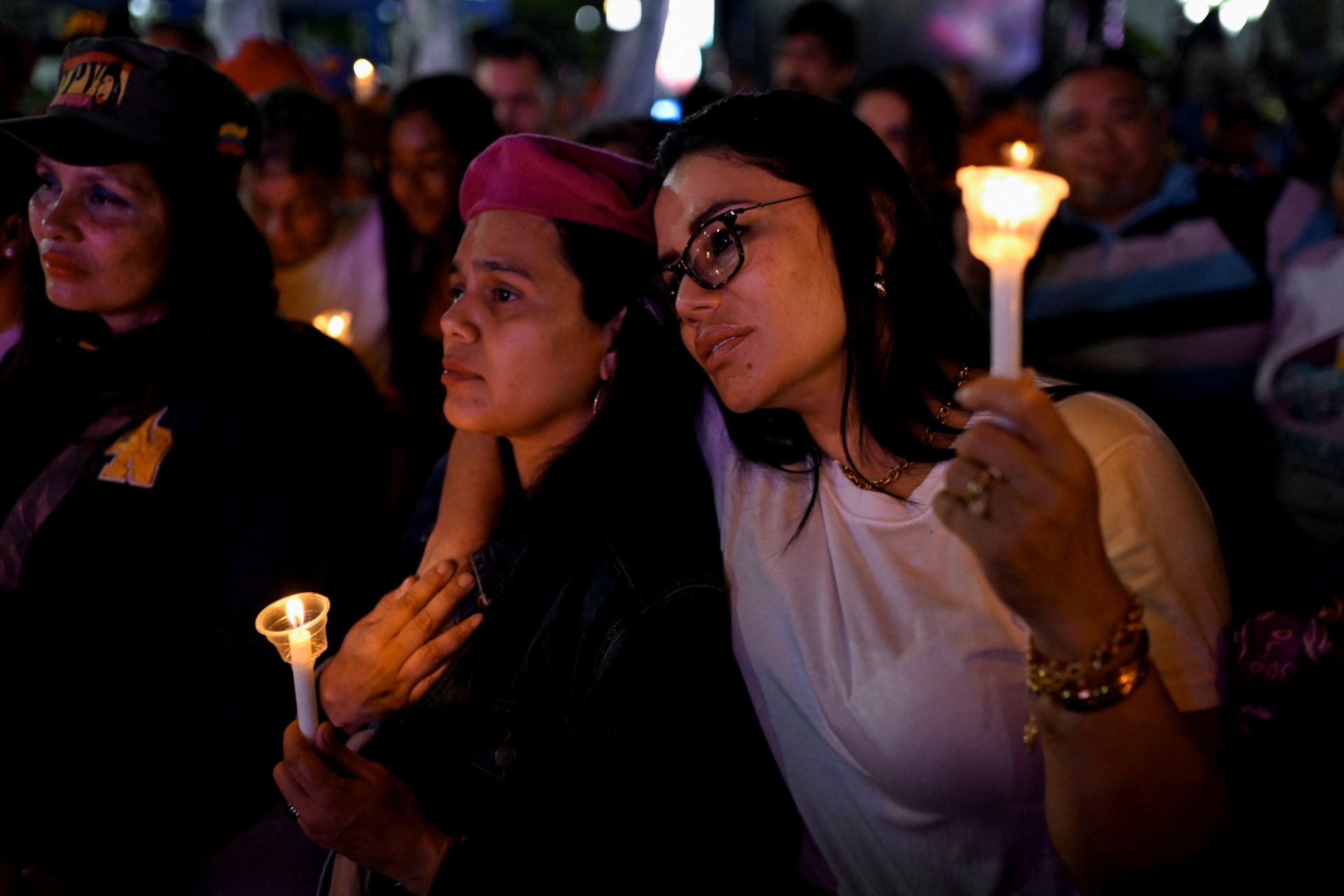 Women hold candles during a vigil to honor those killed on January 3 during the U.S. operation to capture Venezuela's President Nicolas Maduro and his wife Cilia Flores, at Bolivar Square in Caracas, Venezuela, January 22, 2026.