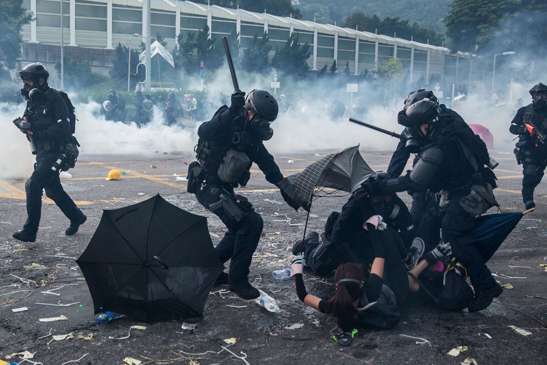 Image of riot police beating pro-democracy protesters.