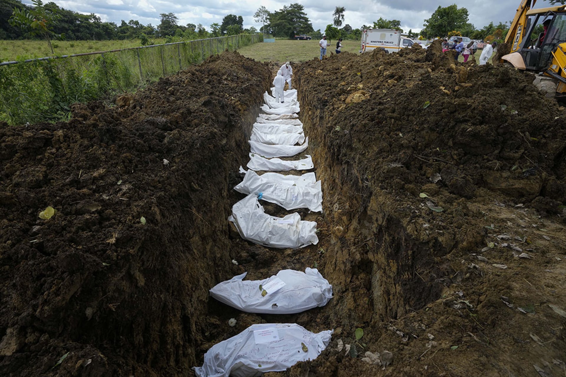 A forensics team bury a group of 15 migrants in a mass grave who died trying to cross the Darien Gap