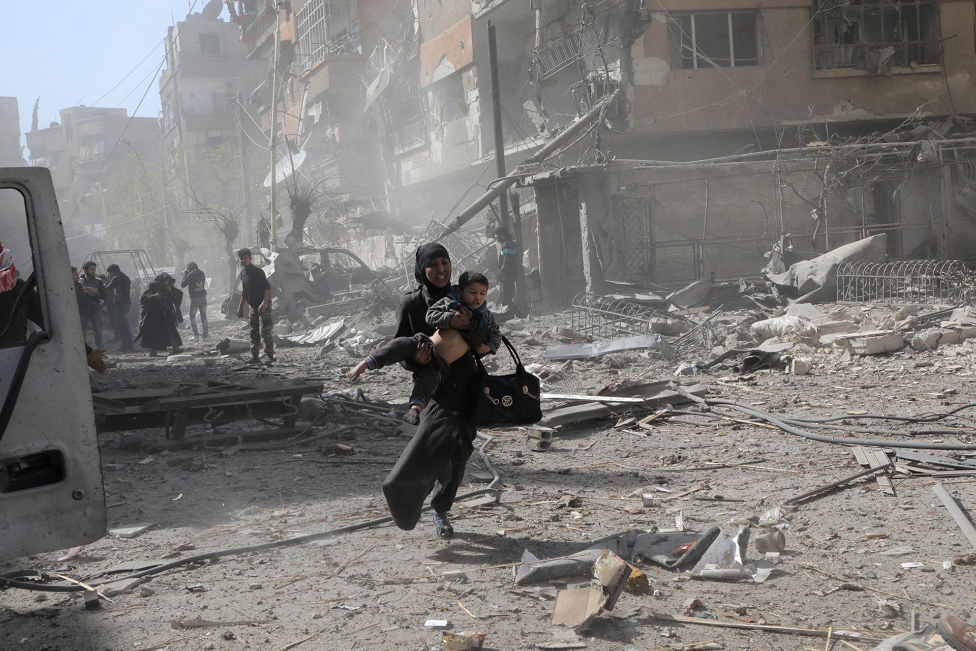 <p>DOUMA, SYRIA: In 2018, government air strikes on the rebel-held enclave of Douma, outside the Syrian capital of Damascus, had devastating effects on civilians. Hamza Al-Ajweh/AFP/Getty Images</p>