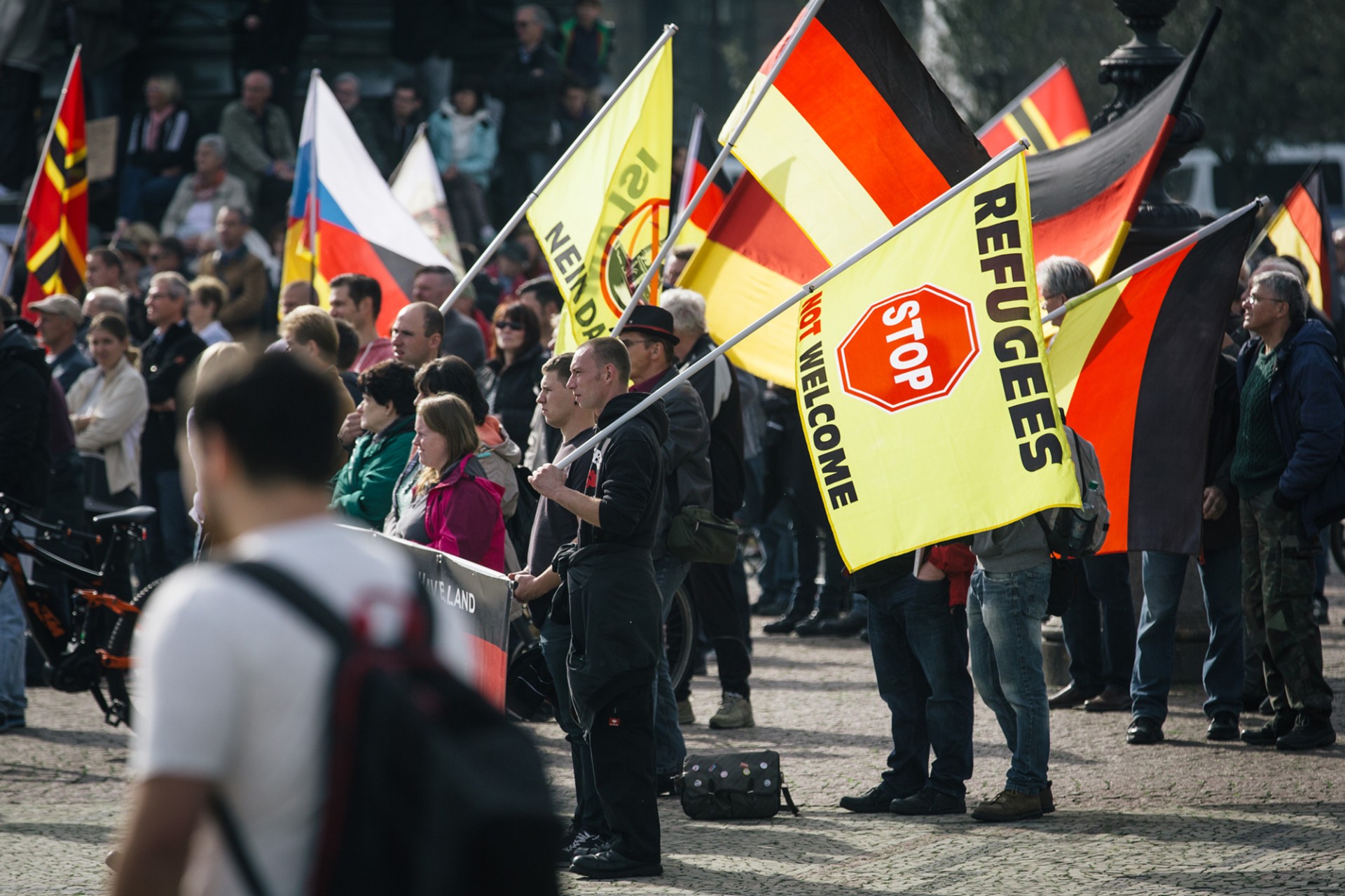<p>DRESDEN, GERMANY: Supporters of the far-right, anti-immigrant movement known as Pegida attend a rally in eastern Germany in 2016. <span class="immersive-image__figcaption-credit">Oliver Killig/DPA/AFP/Getty Images</span></p>