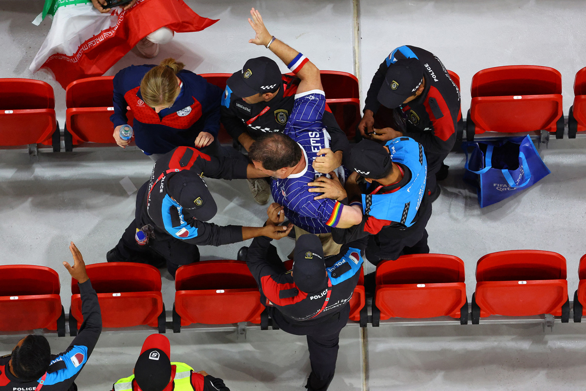 <p>DOHA: Police remove a fan wearing a rainbow-colored arm band from the stands at a FIFA World Cup game, on November 29, 2022.</p>
