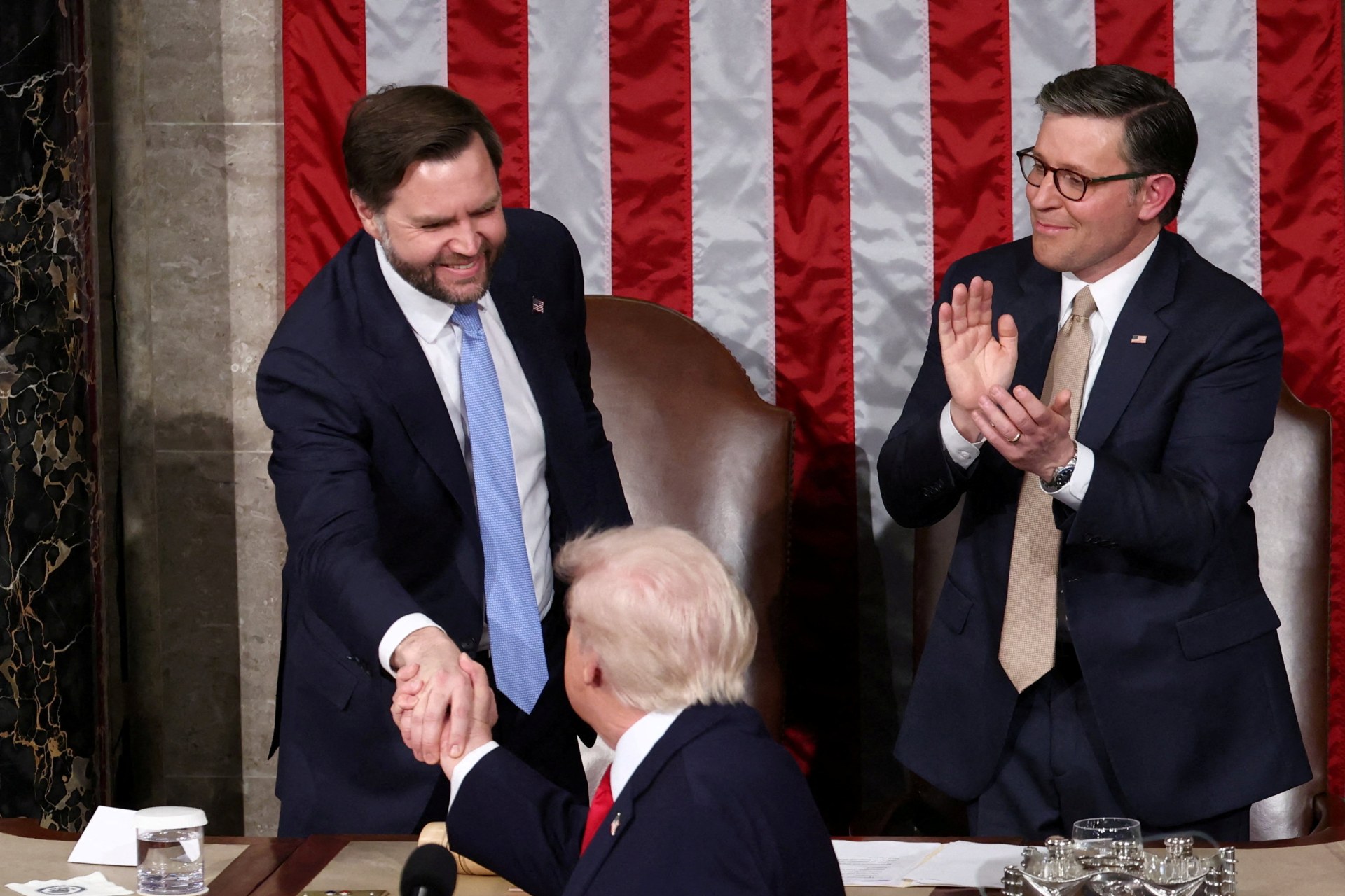 FILE PHOTO: U.S. President Donald Trump shakes hands with Vice President JD Vancei