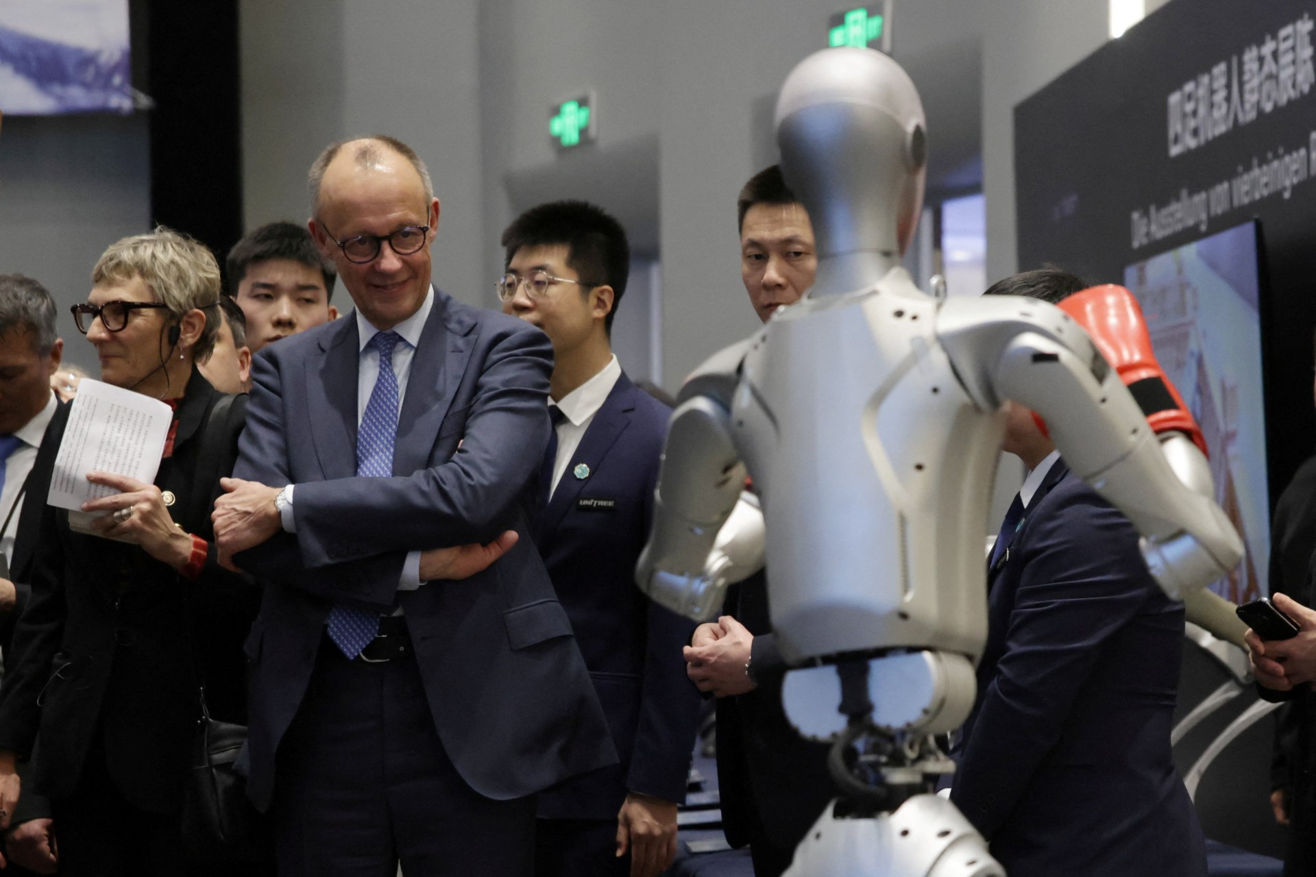 German Chancellor Friedrich Merz attends a performance of a humanoid robot boxing at the Unitree Robotics headquarters during the last day of his official visit to China, in Hangzhou, China, 26 February, 2026. ANDRES MARTINEZ CASARES/Pool via REUTERS