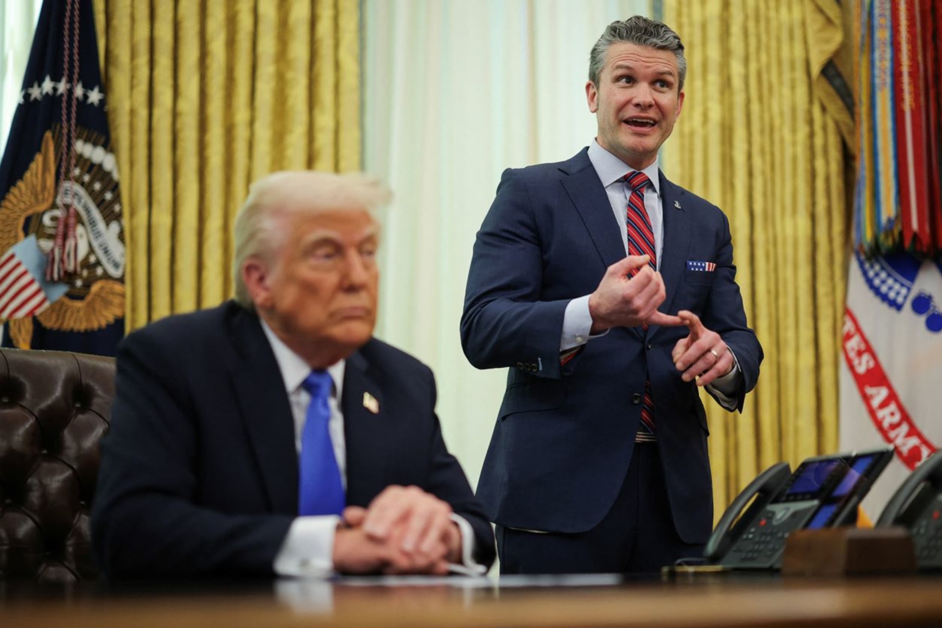 <p>Defense Secretary Pete Hegseth speaks next to President Donald Trump in the Oval Office at the White House in Washington, DC, on Friday, March 21.</p>