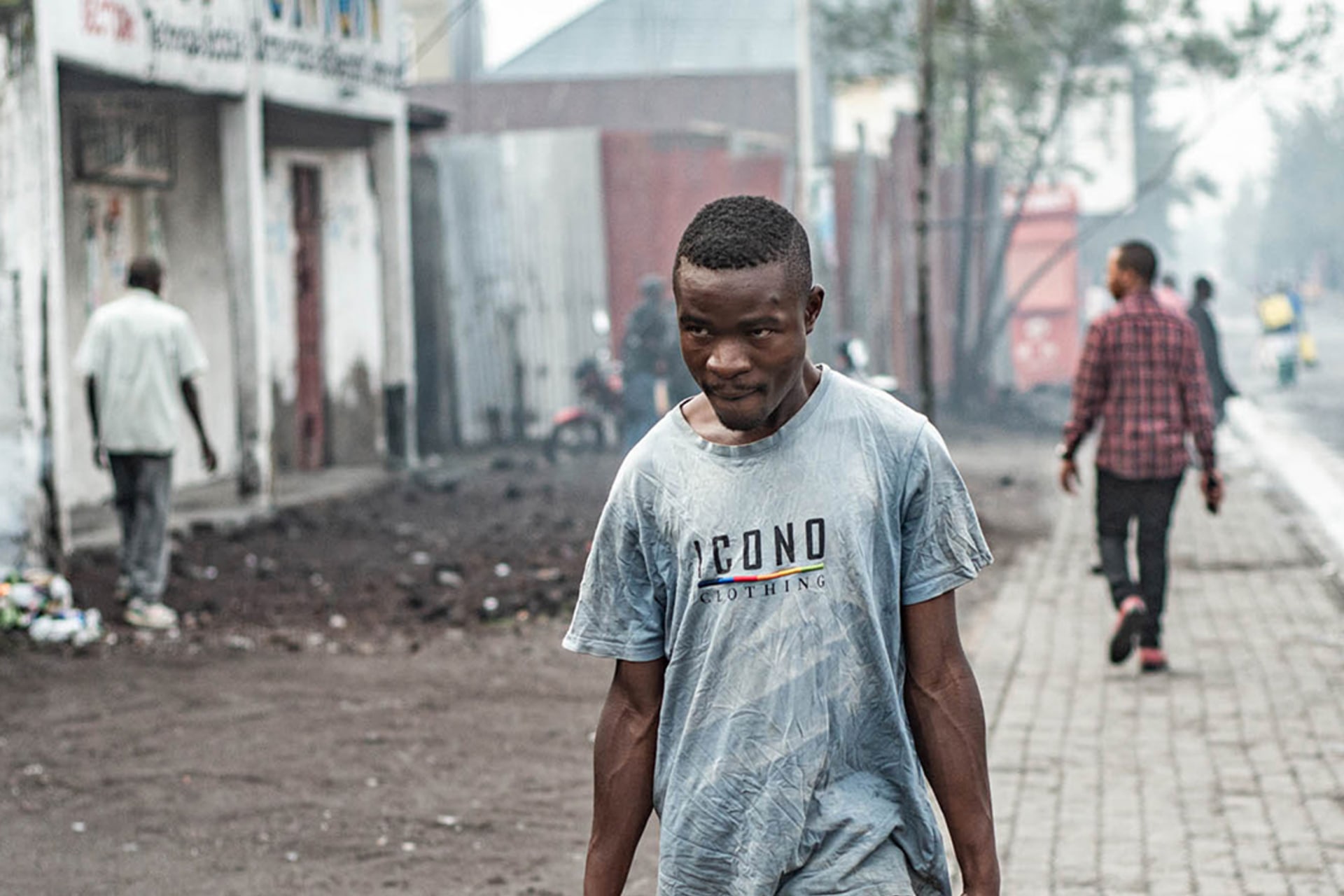 Man carries water jugs in DRC.