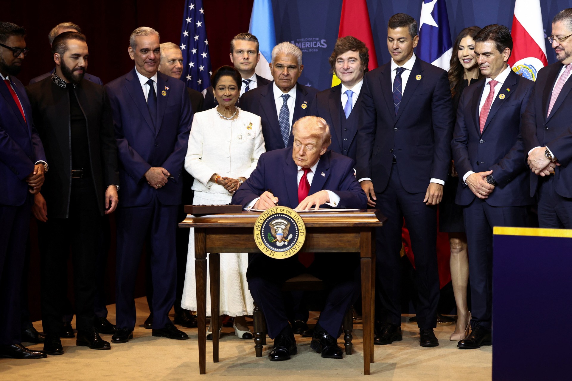 <p>U.S. President Donald Trump signs the “Commitment to countering cartel criminal activity” document during the “Shield of the Americas” Summit in Miami, Florida, U.S., March 7, 2026.</p>

