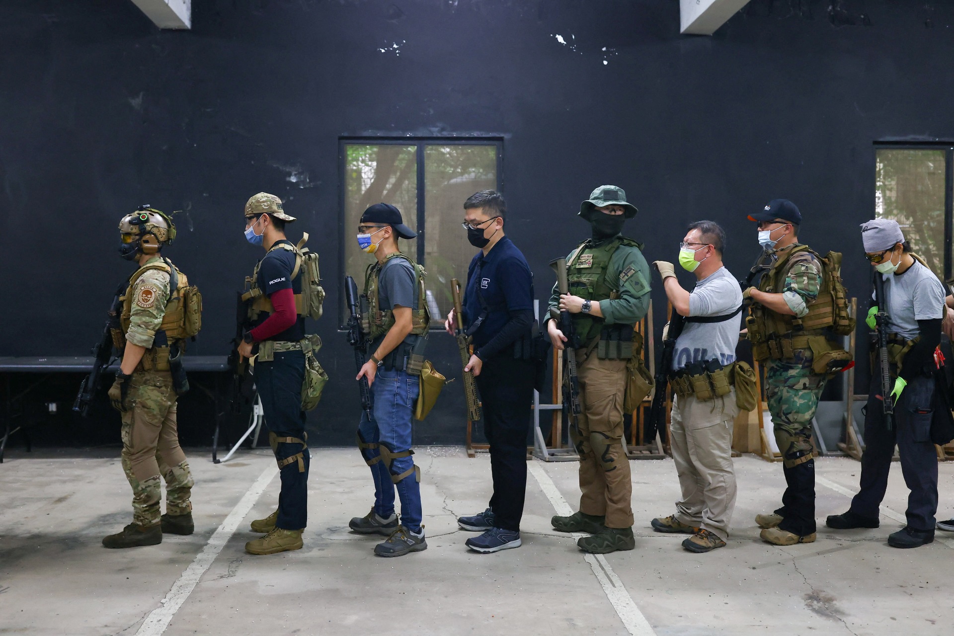 Trainees line up to practice target shooting in New Taipei City, Taiwan, May 21, 2022.