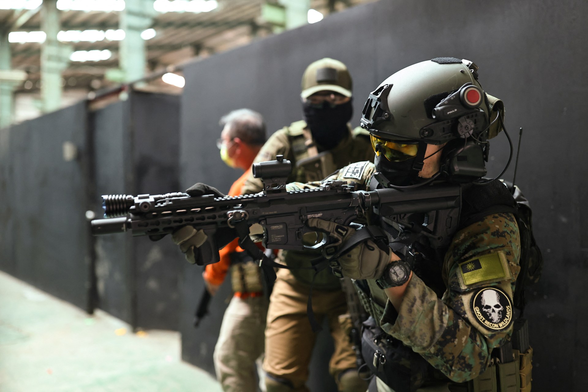 Trainees prepare to enter a building during a shooting lesson in New Taipei City, Taiwan, May 22, 2022