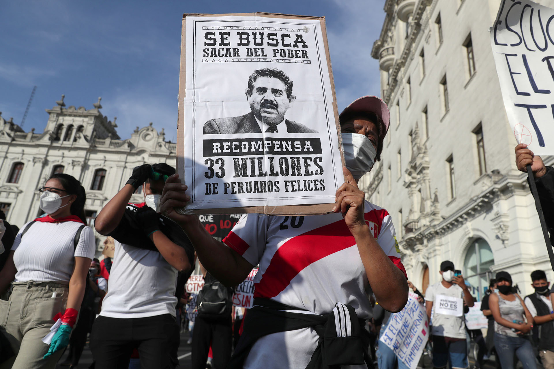 <p>A demonstrator holds a poster with a picture of interim President Manuel Merino as they protest against Congress’s decision to remove former President Martín Vizcarra in Lima, Peru, on November 14, 2020.</p>
