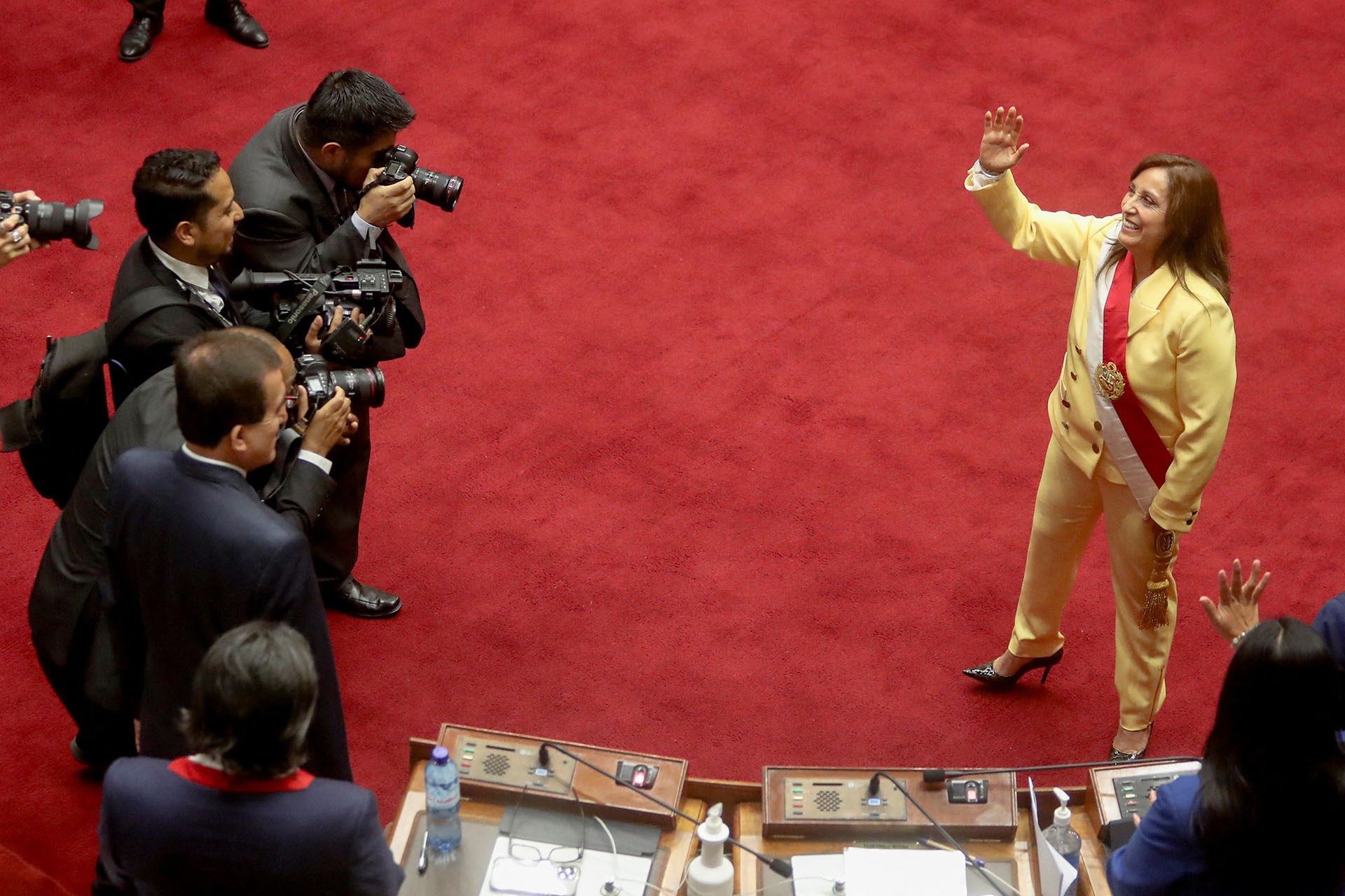 <p>Interim President Dina Boluarte waves after being sworn in following the removal of President Pedro Castillo in an impeachment trial, in Lima, Peru, on December 7, 2022.</p>
