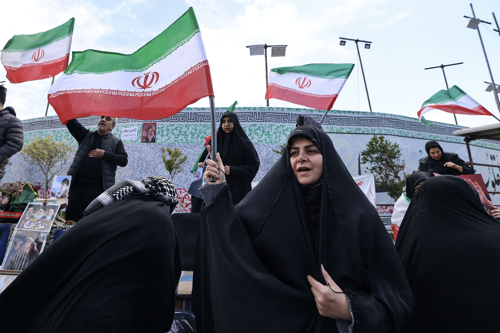 <p>Iranian women wave national flags as people gather in Tehran’s Revolution Square after the United States and Iran agreed to a two-week ceasefire, on April 8, 2026. </p>
