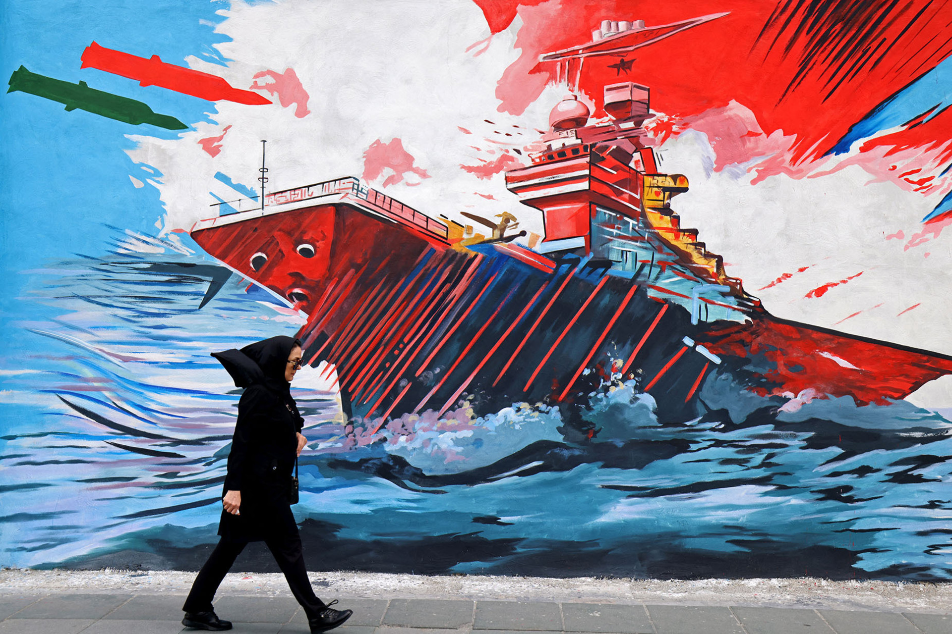 <p>A woman walks past an anti-United States and anti-Israel mural in Tehran on April 8, 2026.</p>
