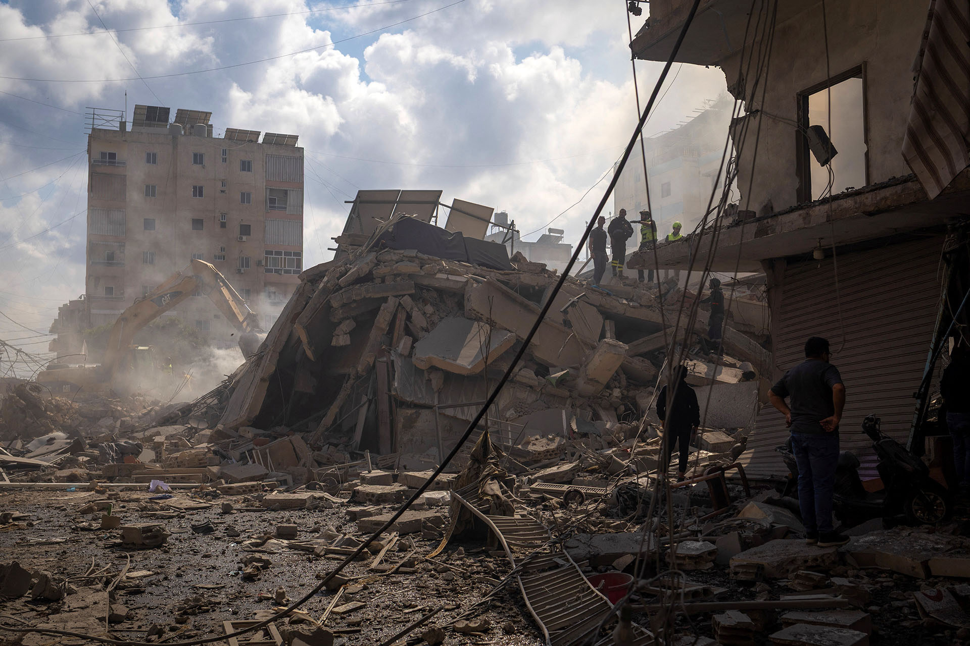 <p>Rescue workers stand amid rubble at the site of an Israeli strike in Tyre, Lebanon, on April 8, 2026.</p>
