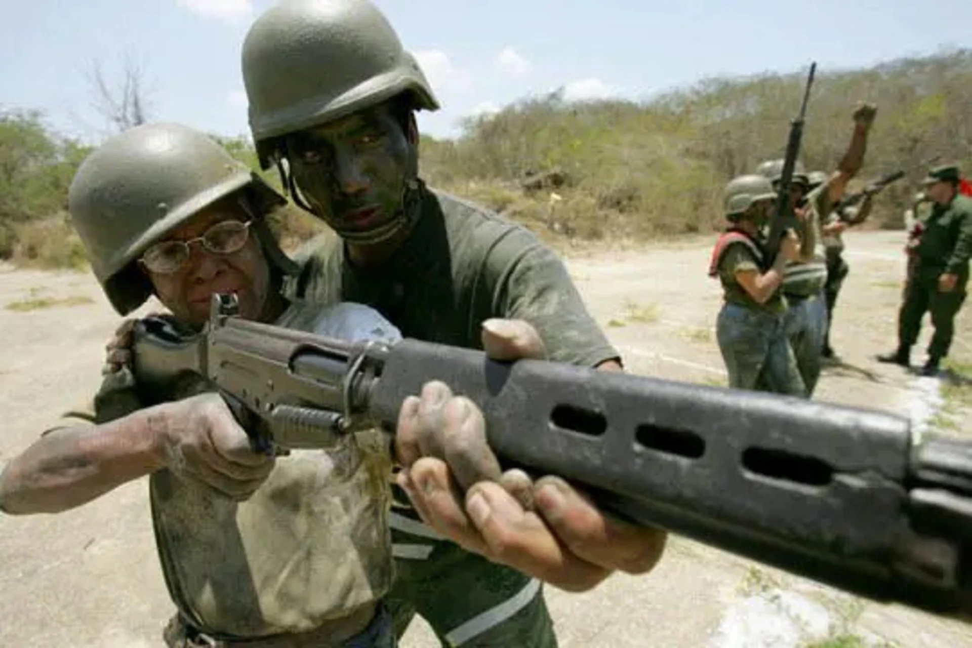 An army officer trains a civilian at a base outside Caracas. 
