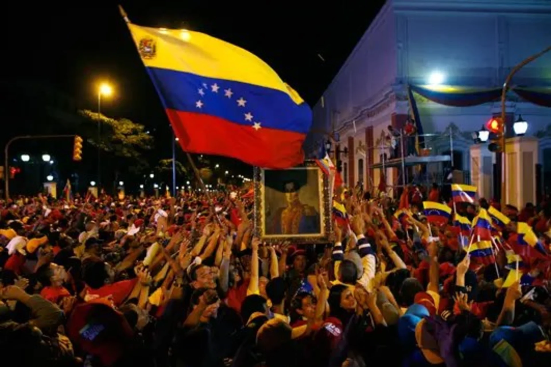 Chavez supporters mob the gate of Miraflores Palace in Caracas after the referendum to abolish term limits passes. 