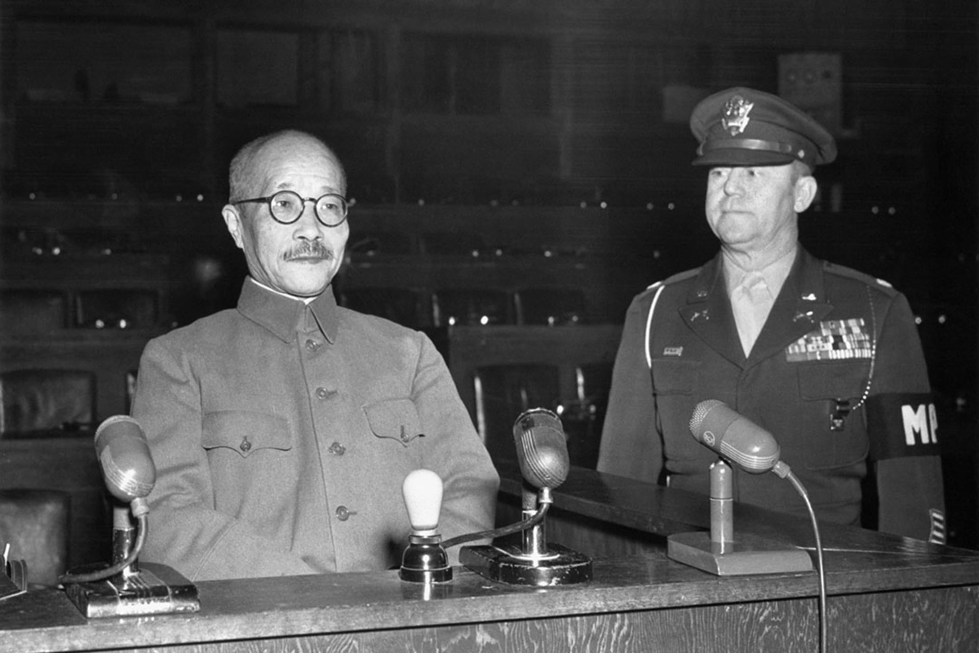 Former Japanese Prime Minister Tojo Hideki sits in a witness chair before the Tokyo war crimes tribunal.