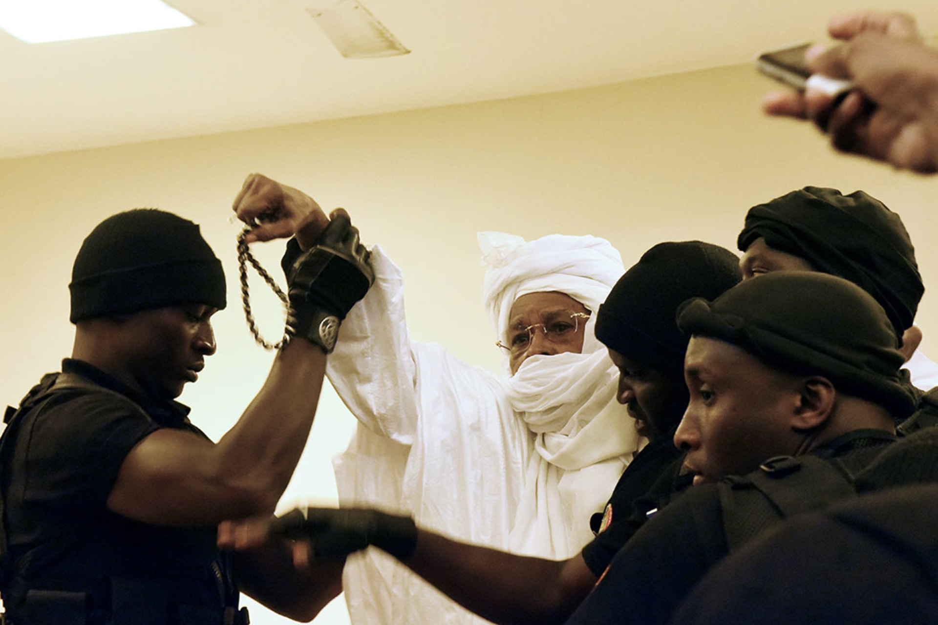 Prison guards escort former Chadian dictator Hissene Habre into the courtroom for his trial by the Extraordinary African Chambers in Dakar, Senegal.