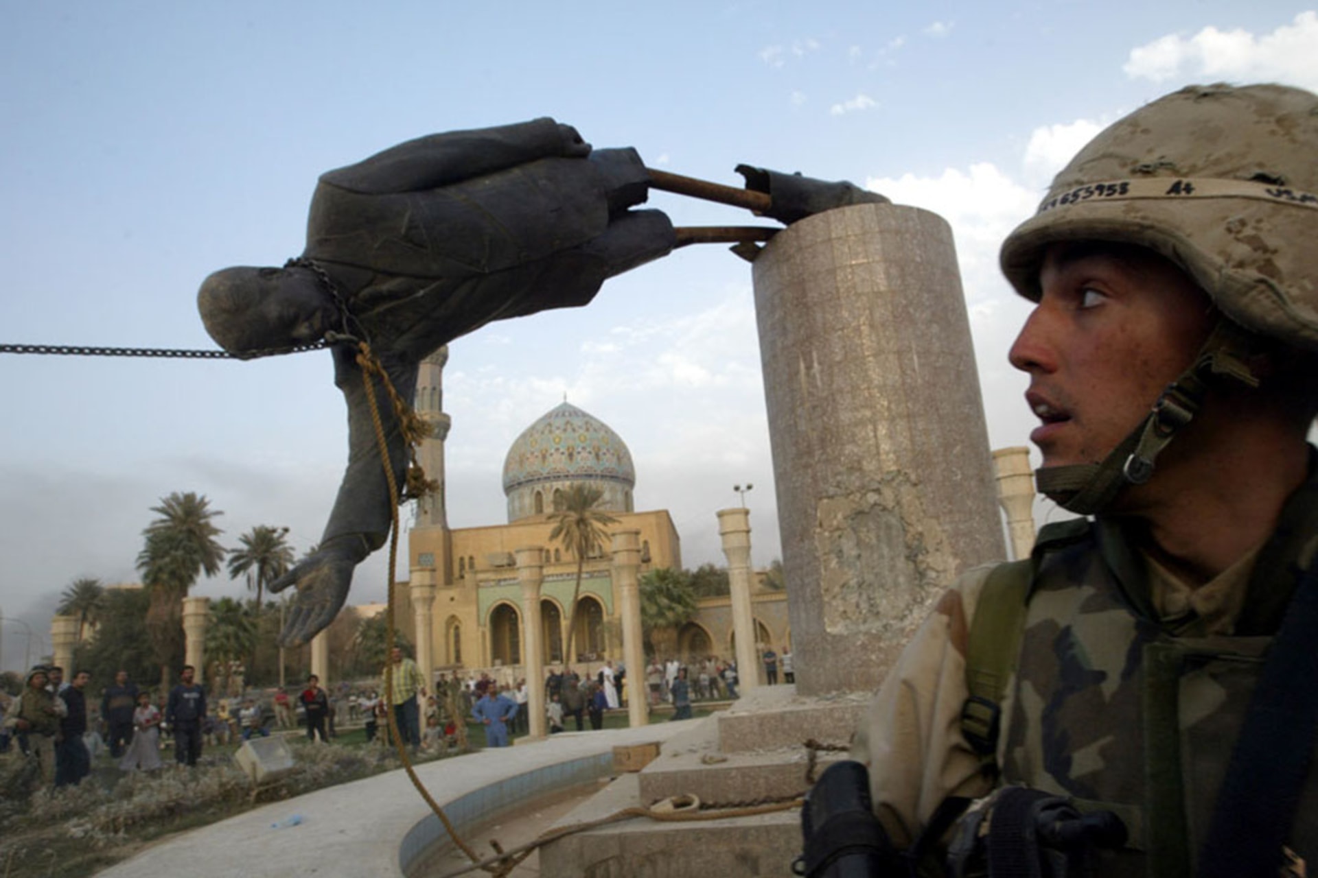 U.S. troops pull down a twenty-foot statue of Saddam Hussein in central Baghdad. 