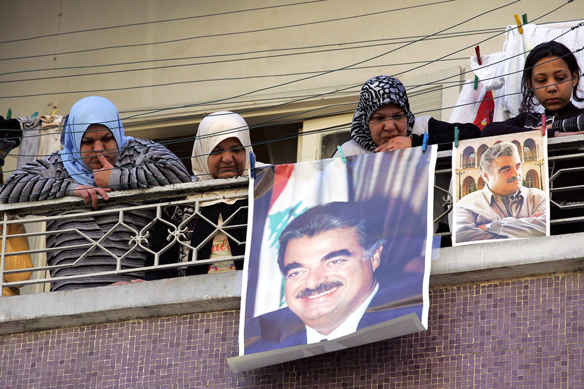 Sunni Muslim women in Beirut brandish posters of assassinated former Lebanese Prime Minister Rafiq Hariri. 
