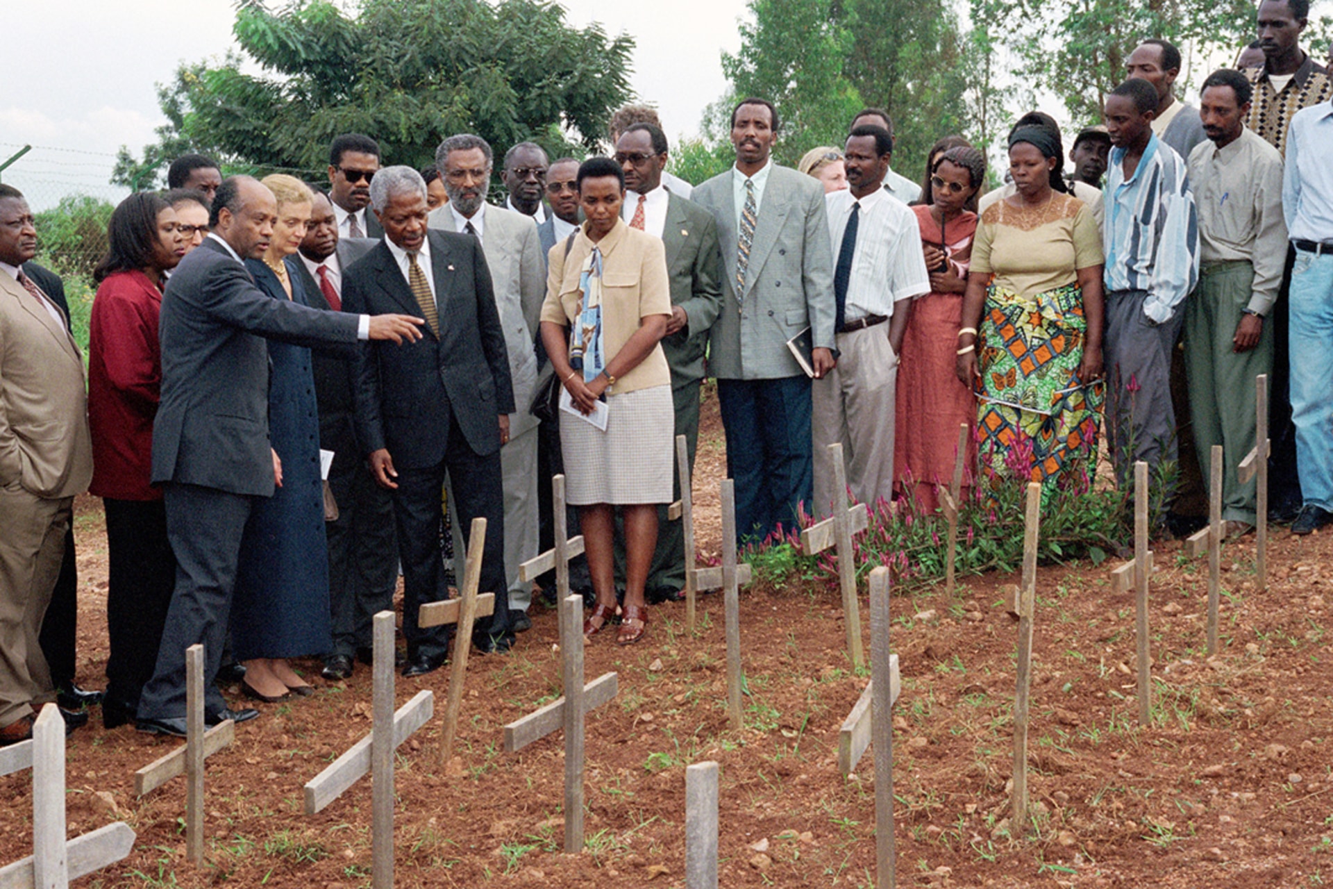 UN Secretary-General Kofi Annan and his wife, Nane, visit the burial site of genocide victims from the École Technique Officielle secondary school in Kigali, Rwanda, May 1998. Milton Grant/UN Photo