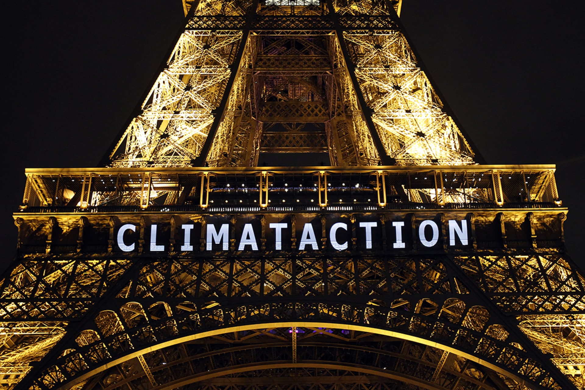 The slogan “climate action” is projected onto the Eiffel Tower during the UN climate conference in Paris, France, December 11, 2015. Chesnot/Getty Images