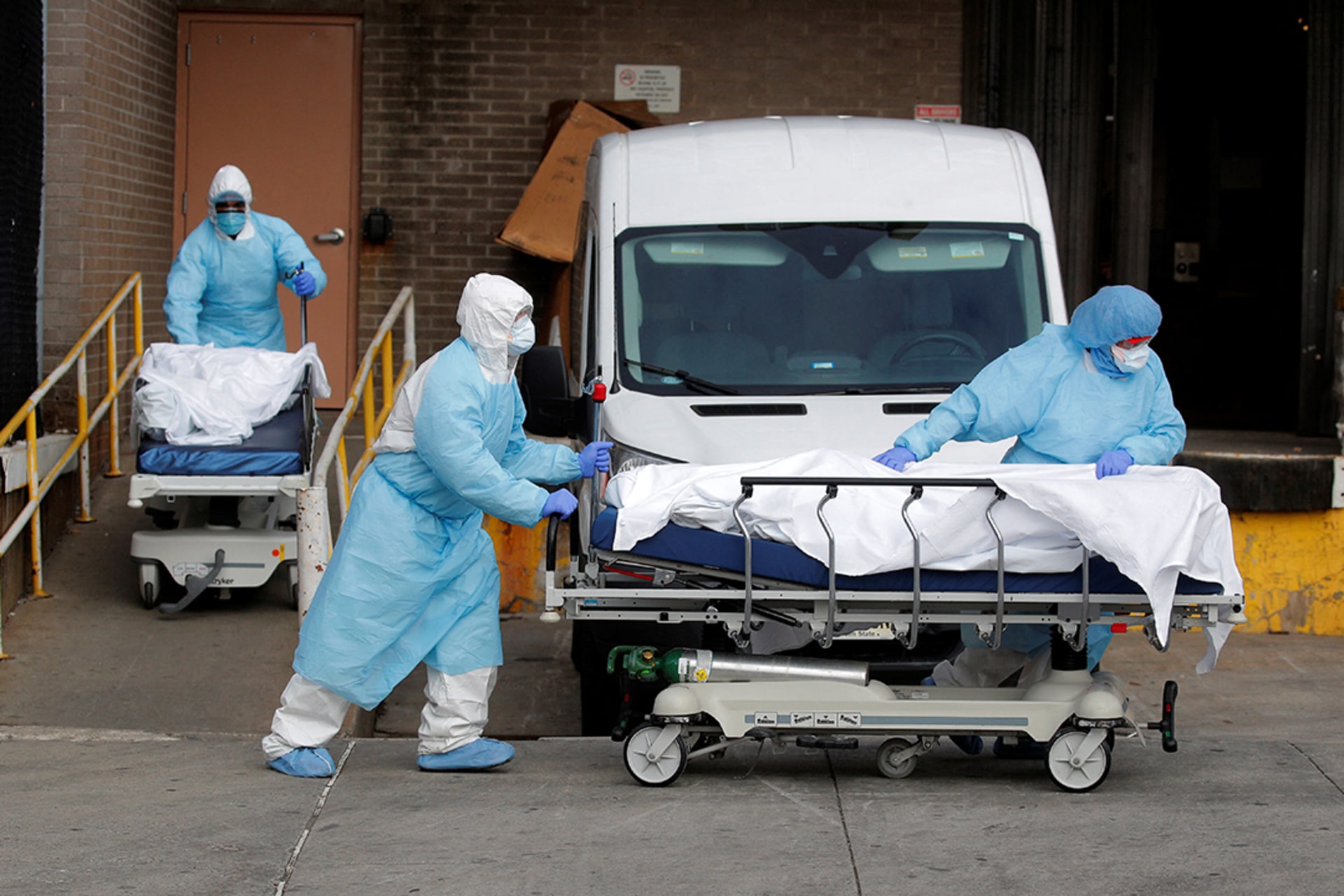 Health-care workers wheel bodies from the Wyckoff Heights Medical Center in Brooklyn, New York, during the COVID-19 pandemic, April 2, 2020. Brendan McDermid/Reuters