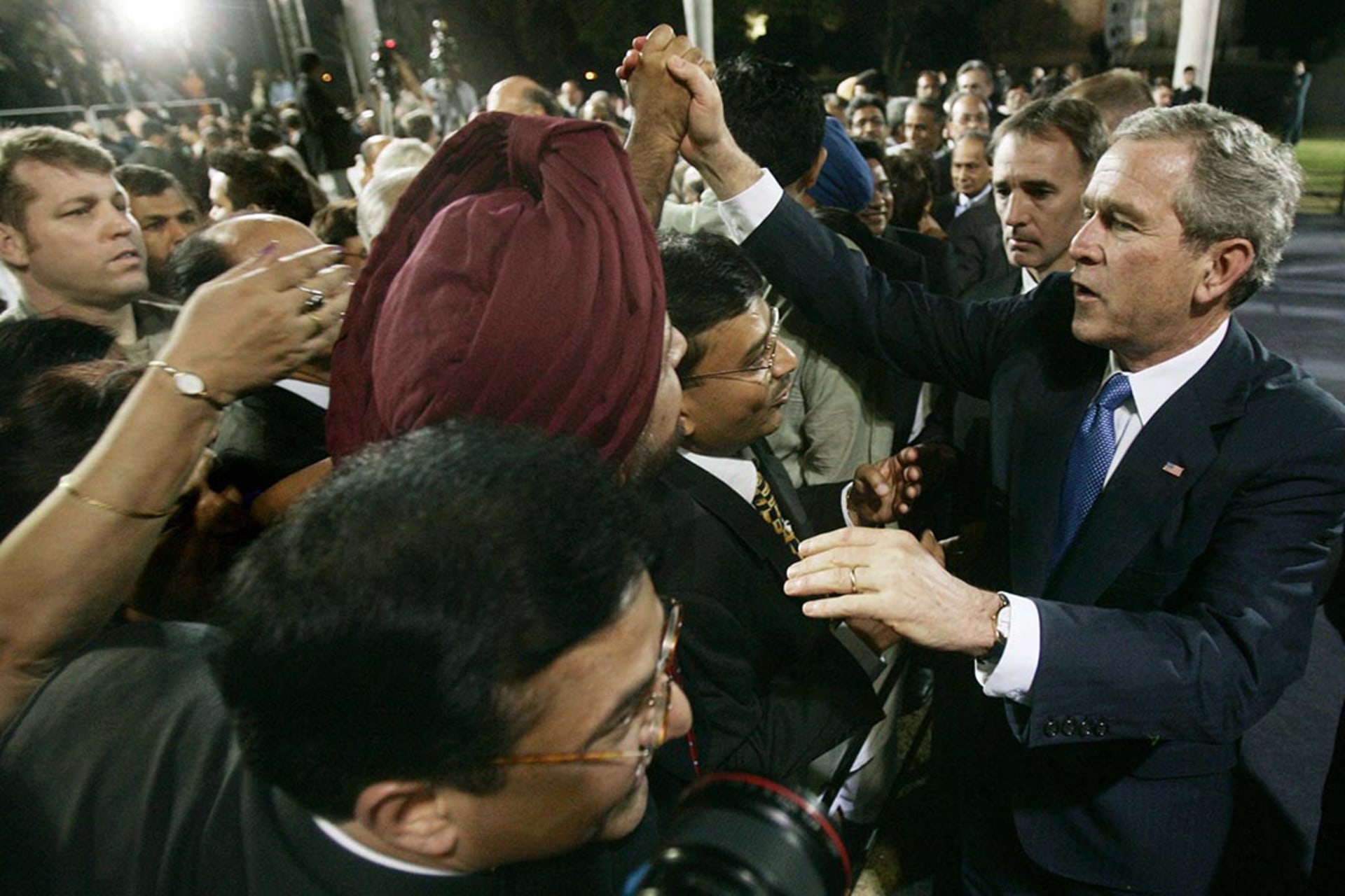 U.S. President George W. Bush greets people after a speech in New Delhi. Jim Young/Reuters