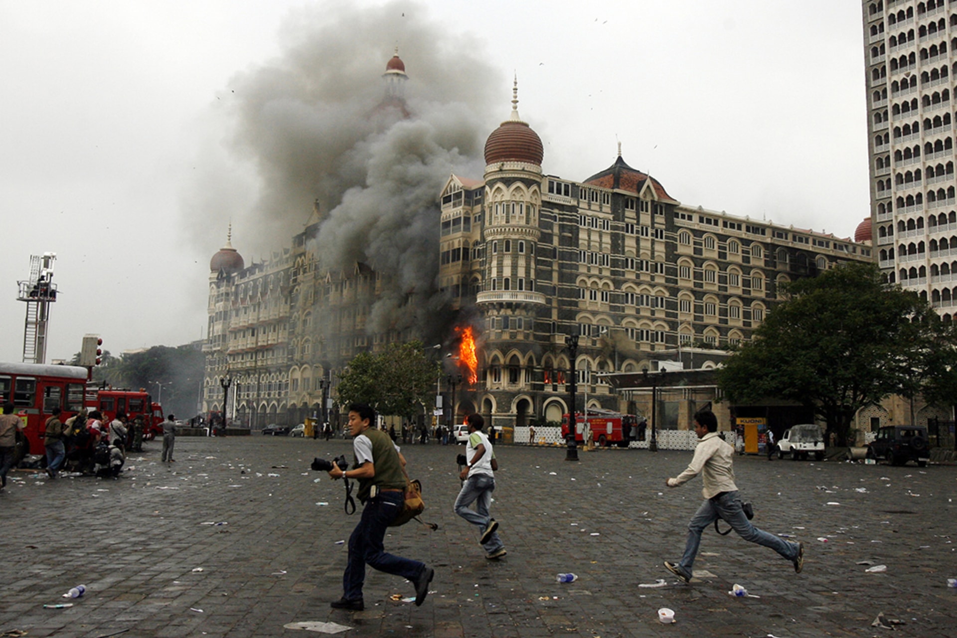 Photographers run past a burning Taj Mahal Hotel. Punit Paranjpe/Reuters