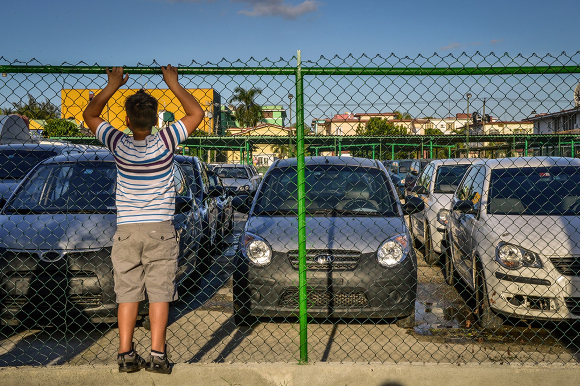 A boy looks at used cars for sale in Havana in January 2014. 
