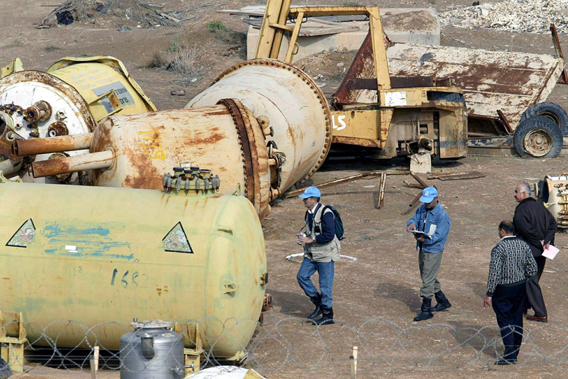 A team of UN weapons inspectors search an Iraqi military industrial site for weapons of mass destruction near the town of Fallujah in December 2002. Suhaib Salem/Reuters