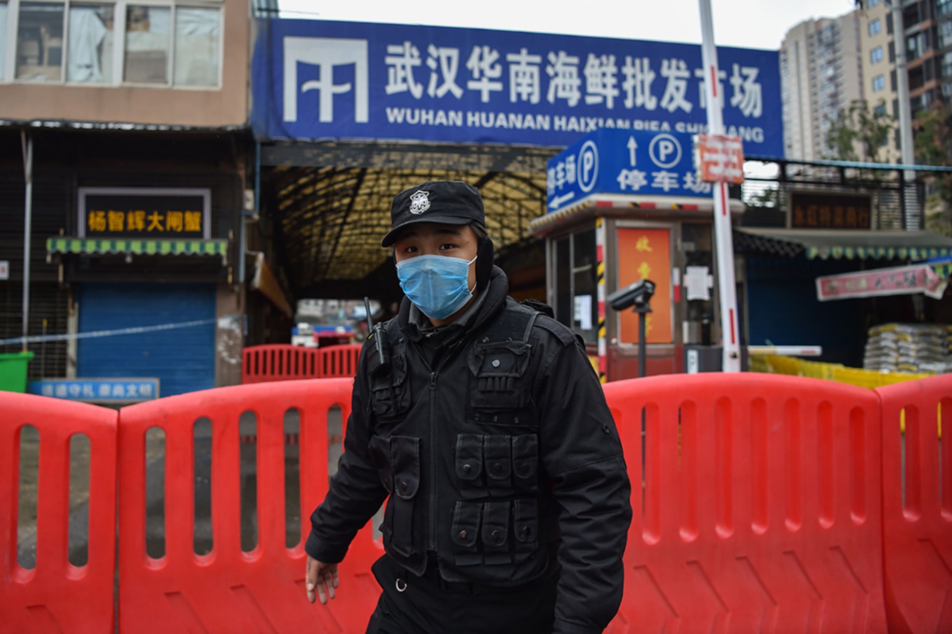A police officer guards an animal market in Wuhan, China, where a new coronavirus was reported in January. 
