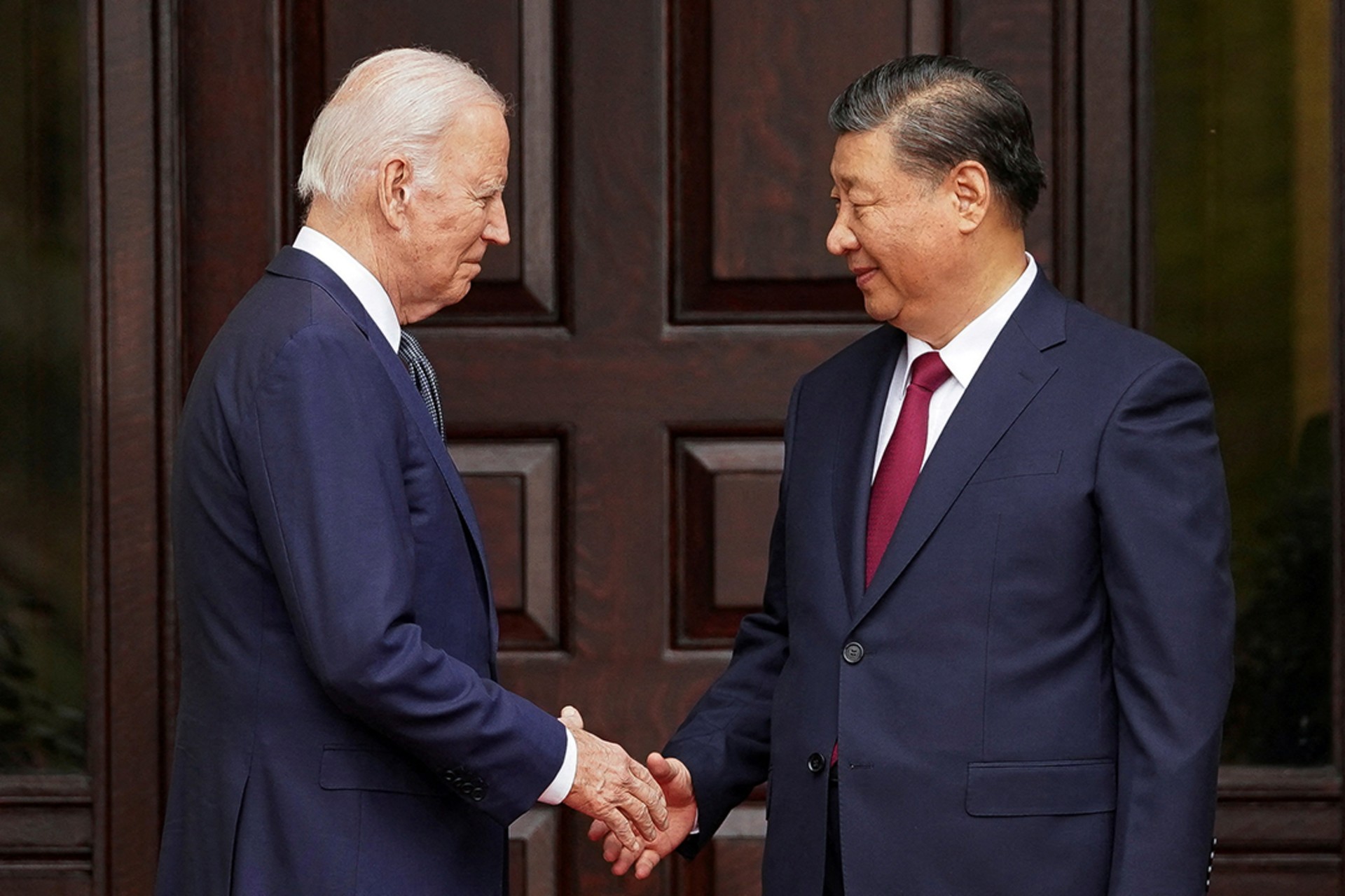 Biden shakes hands Xi in Woodside, California, on November 15, 2023. 

