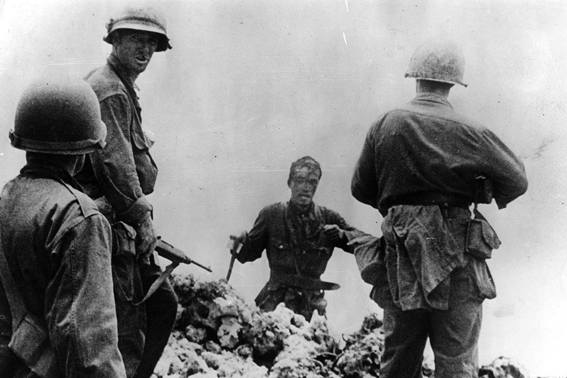 A Japanese officer surrenders to U.S. armed forces. 
