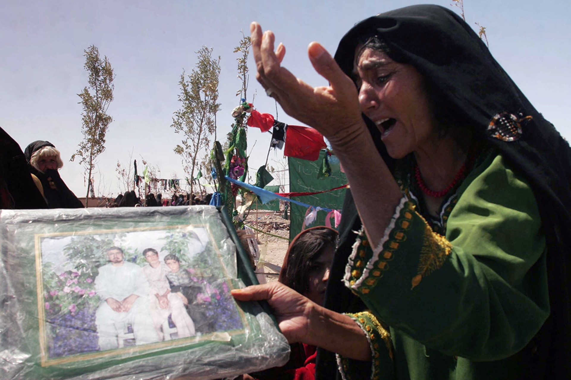 An Afghan woman mourns family members who were killed in Herat Province in August 2008.