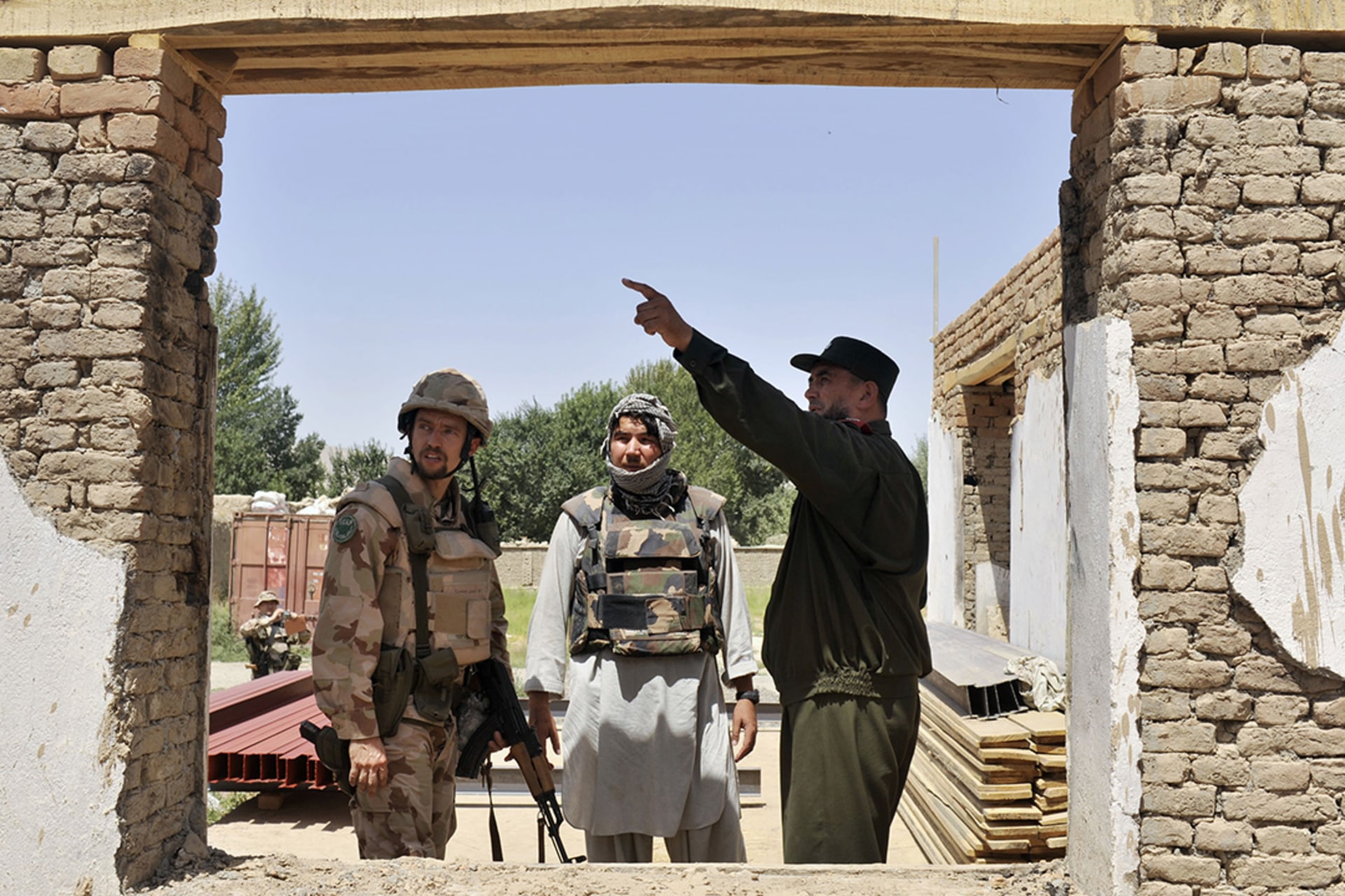 An Afghan town leader with a Hungarian ISAF soldier, Burka, Afghanistan, 2009. 
