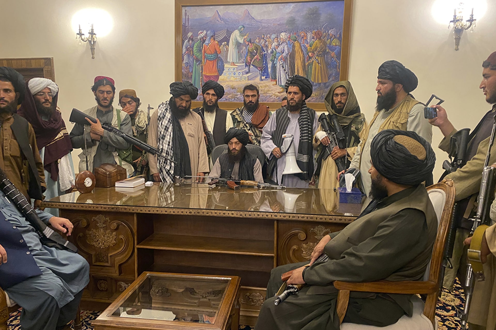Taliban fighters pose in Afghanistan’s presidential palace. 
