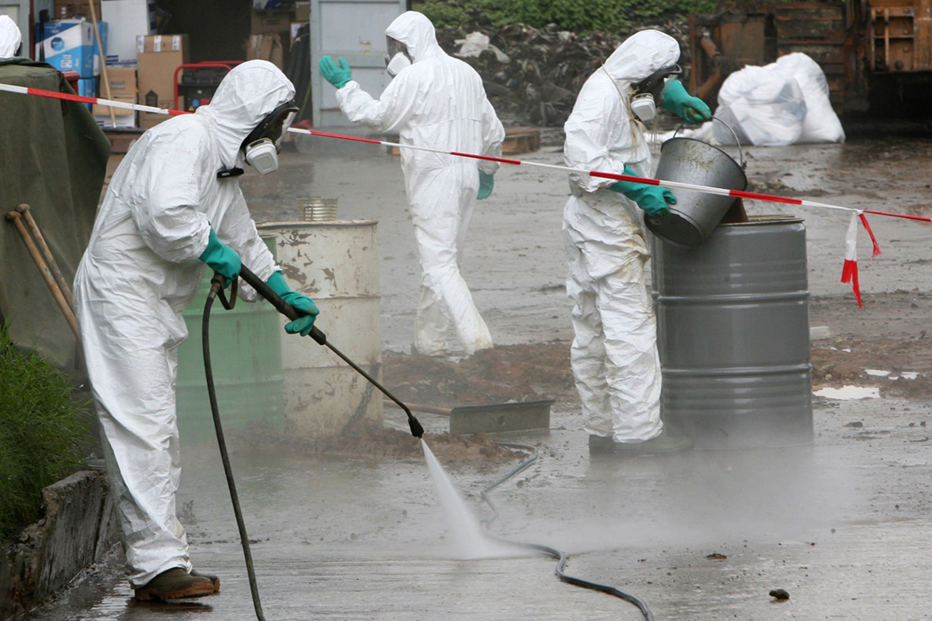 Experts clean up toxic chemical slops dumped in the Ivory Coast’s Akuedo village, September 18, 2006.