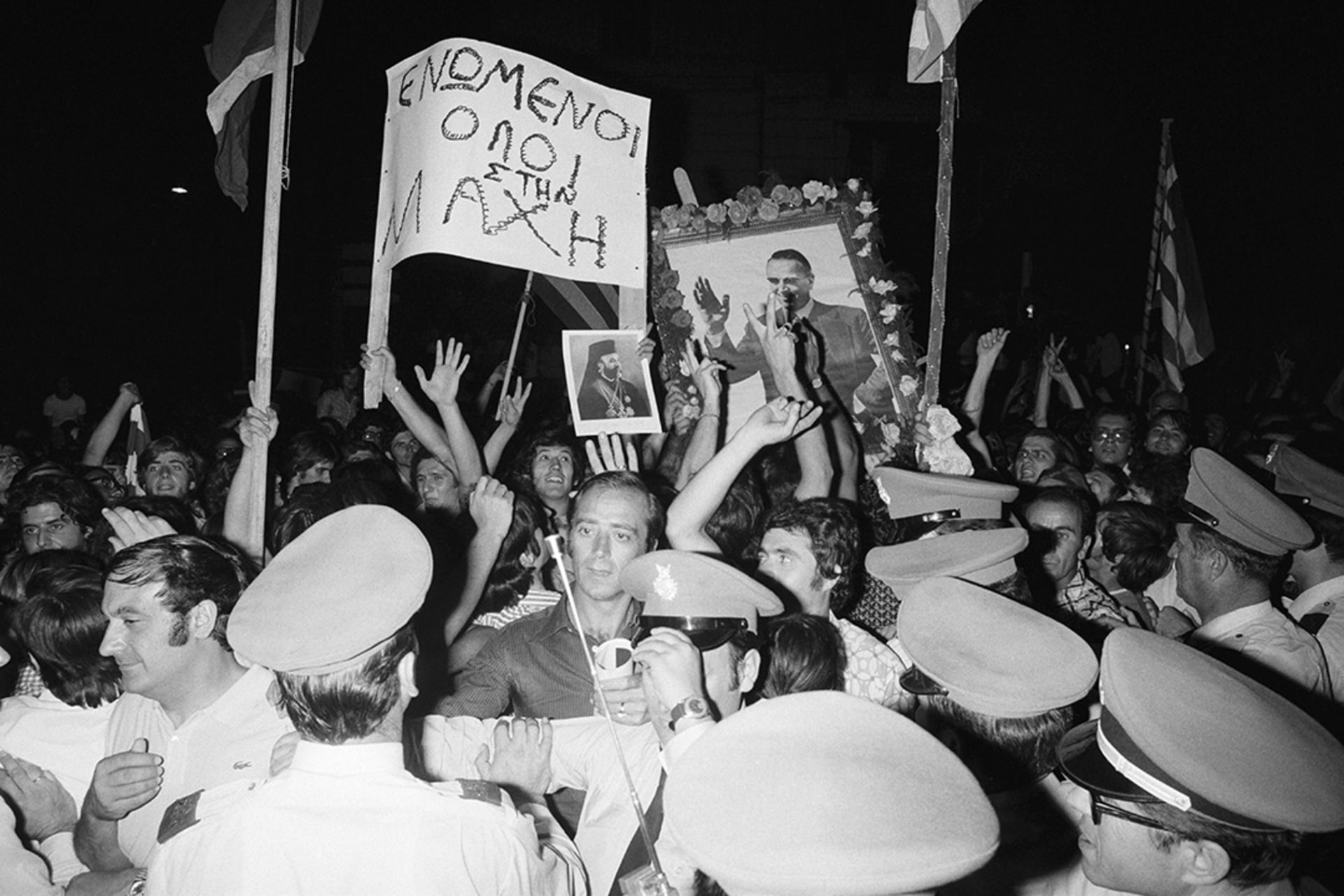 People celebrate the fall of the Greek military junta in the streets of Athens.