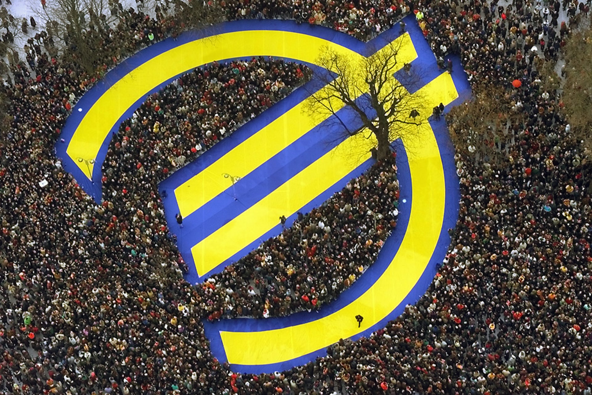 Thousands of people crowd around a huge euro symbol in Frankfurt's banking district on January 1, 1999, in celebration of the launch of the common currency.