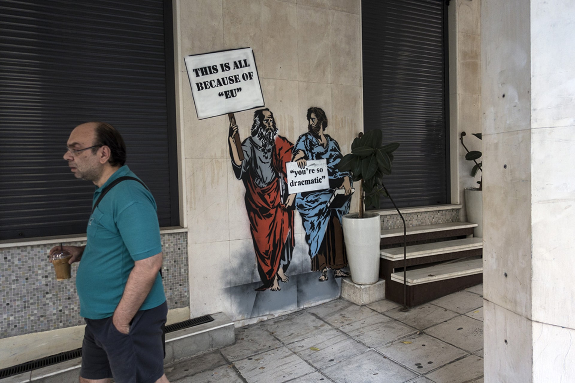 Closed shops in central Athens in August 2018, covered in protest graffiti against the country’s EU creditors. 
