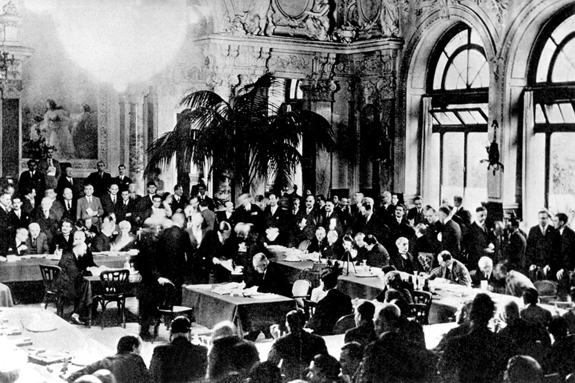 Representatives from France, Germany, and the United Kingdom meet at the Lausanne Conference of 1932 to discuss suspending reparations imposed on countries defeated in World War I. 
