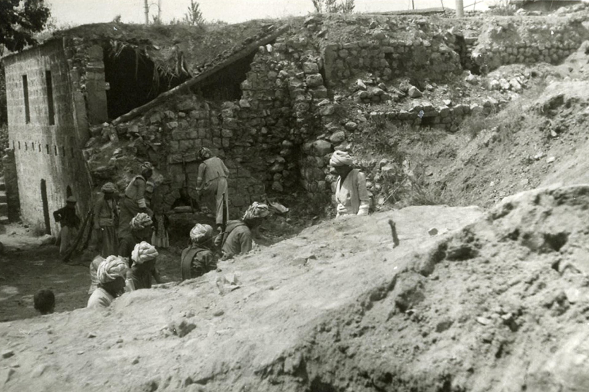 People examine the aftermath of a napalm attack on a mosque in the Kurdish-inhabited city of Barzan, Iraq, in 1961.