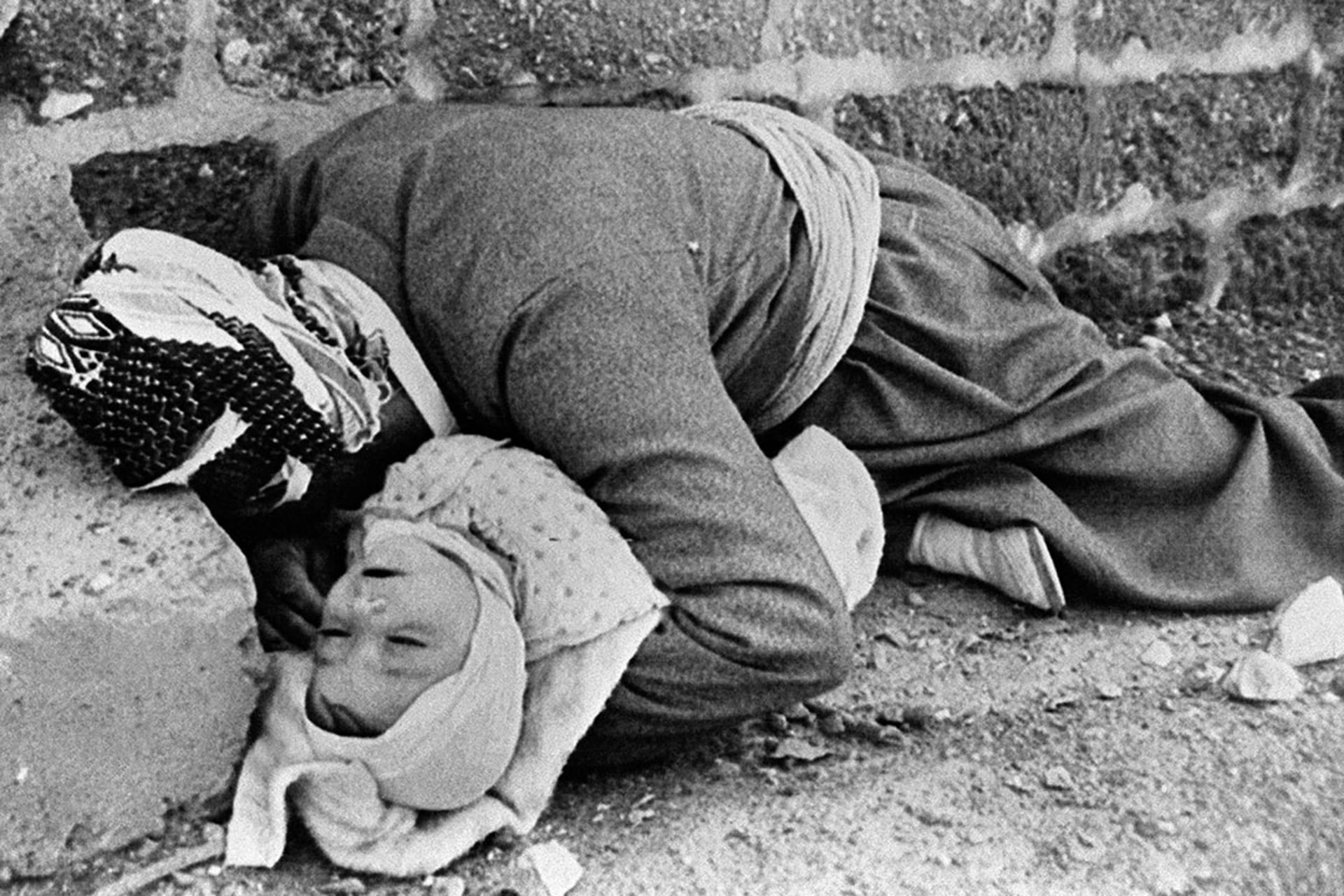 A father and an infant are killed in a chemical attack carried out by Saddam on Halabja, in northeastern Iraq, in March 1988. 
