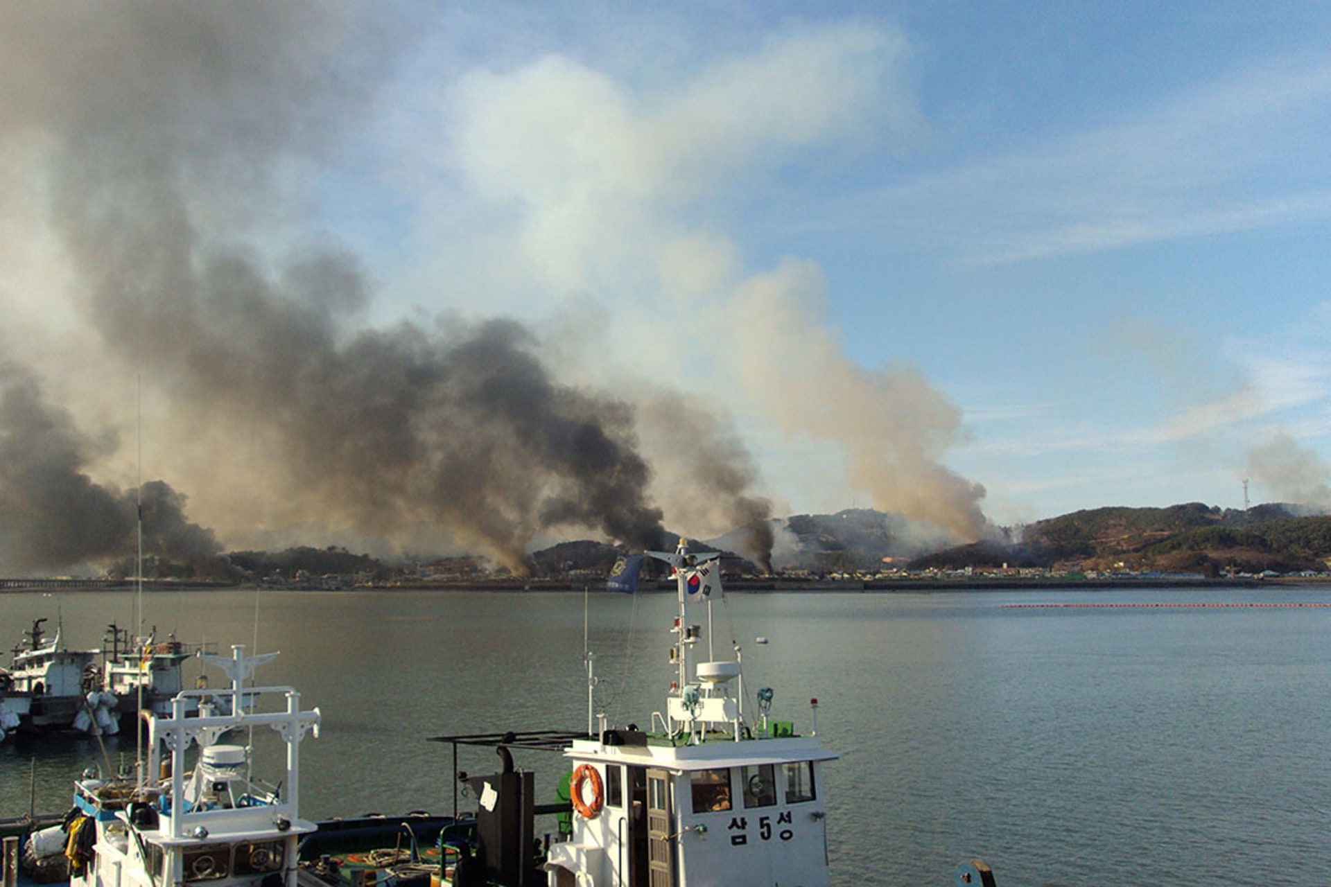 Smoke rises from Yeonpyeong after North Korean artillery hit the South Korean island. Getty Images