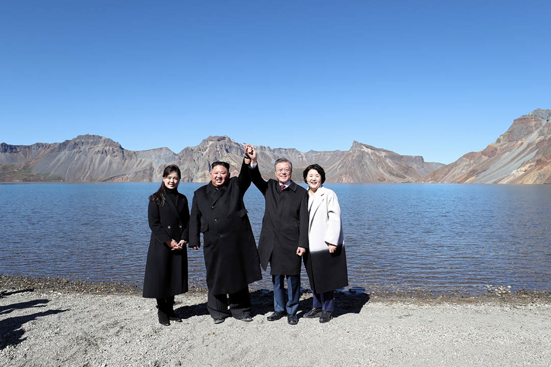 South Korean President Moon Jae-in and his wife, Kim Jung-sook, pose for photographs with North Korean leader Kim Jong-un and his wife, Ri Sol-ju, at the Heaven Lake of Mt. Paektu in North Korea. Pyeongyang Press Corps/Reuters