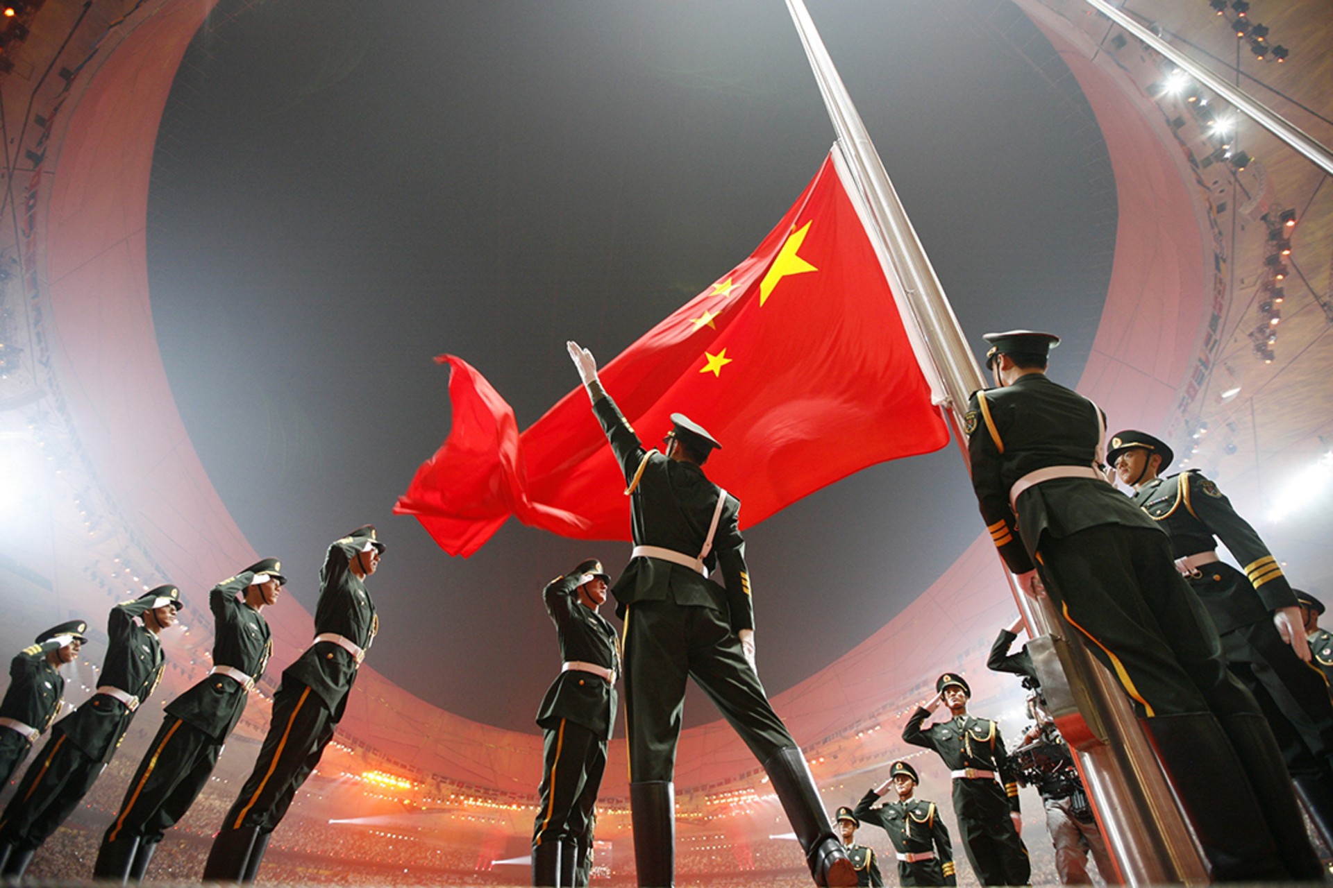 Soldiers raise China’s national flag in Beijing during the opening ceremony of the first games held in the country. Jerry Lampen/Reuters