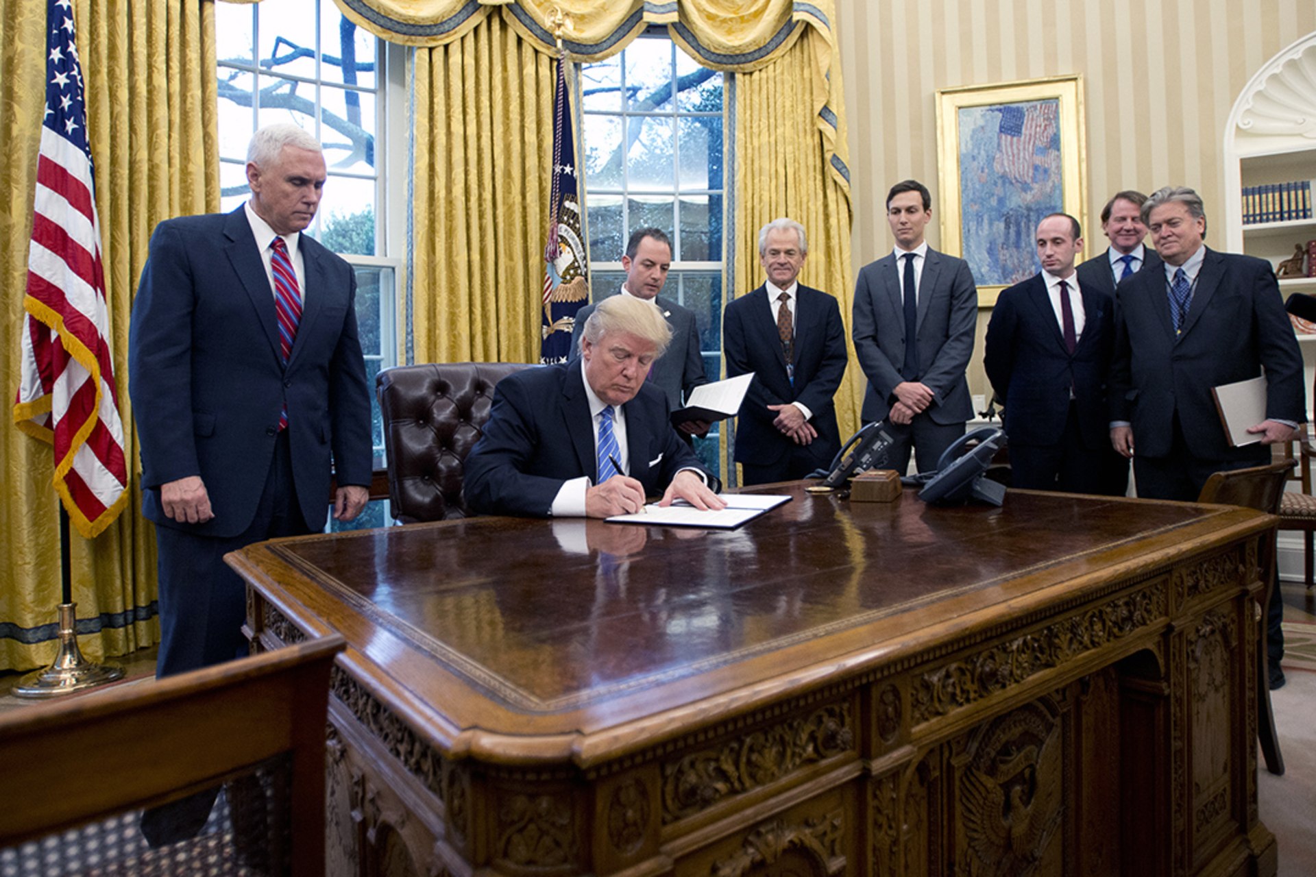 Trump signs an executive order withdrawing the United States from the Trans-Pacific Partnership. Ron Sachs/Pool/Getty Images