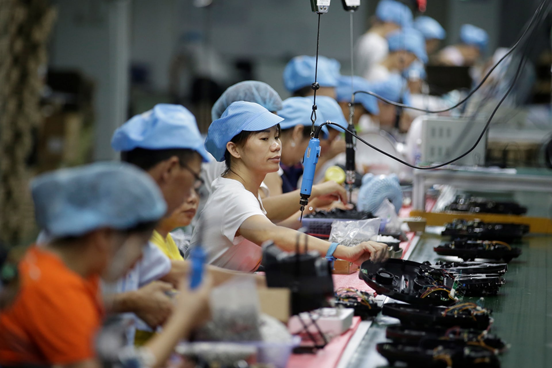 Workers on the production line of a factory in Shenzhen, China, in August 2019. Jason Lee/Reuters